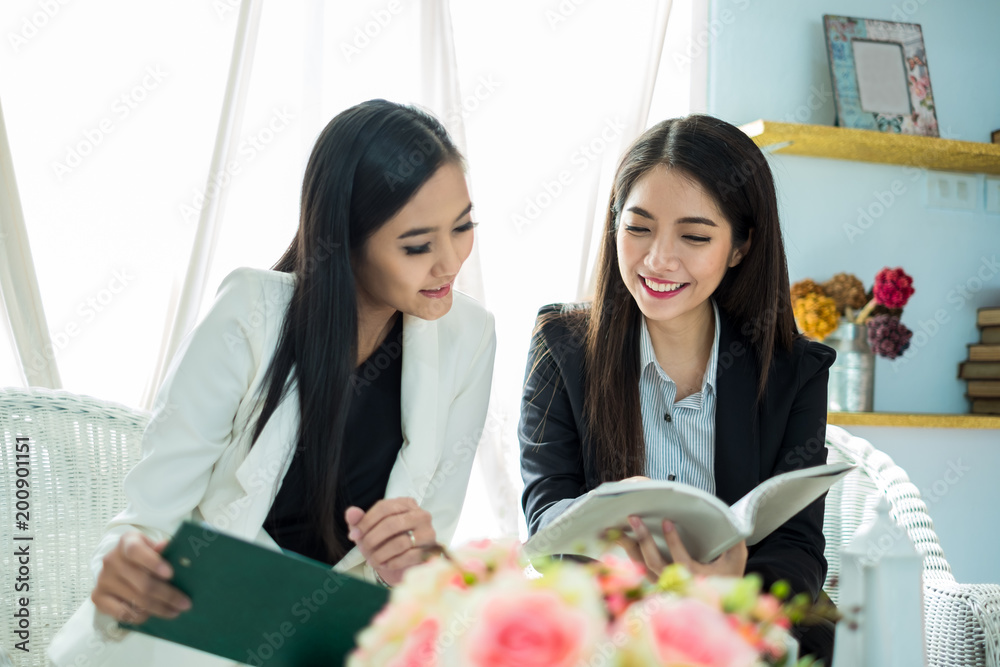 年轻的亚洲女商人在现代办公室里，在会议和办公室里与同事讨论业务