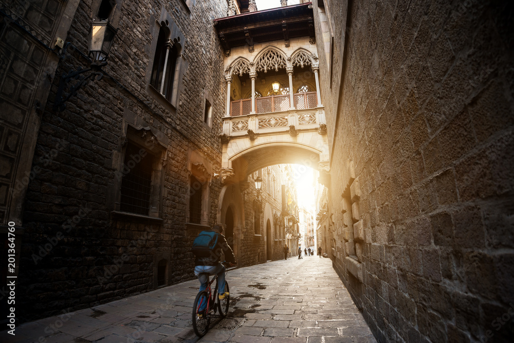 巴塞罗那人在加泰罗尼亚巴塞罗那的巴里哥特式区和叹息桥骑自行车，