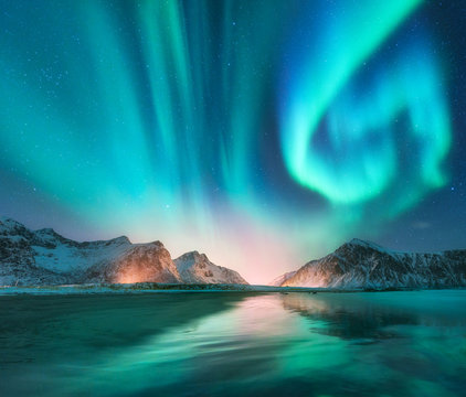 Aurora borealis in Lofoten islands, Norway. Aurora. Green northern lights. Starry sky with polar lig