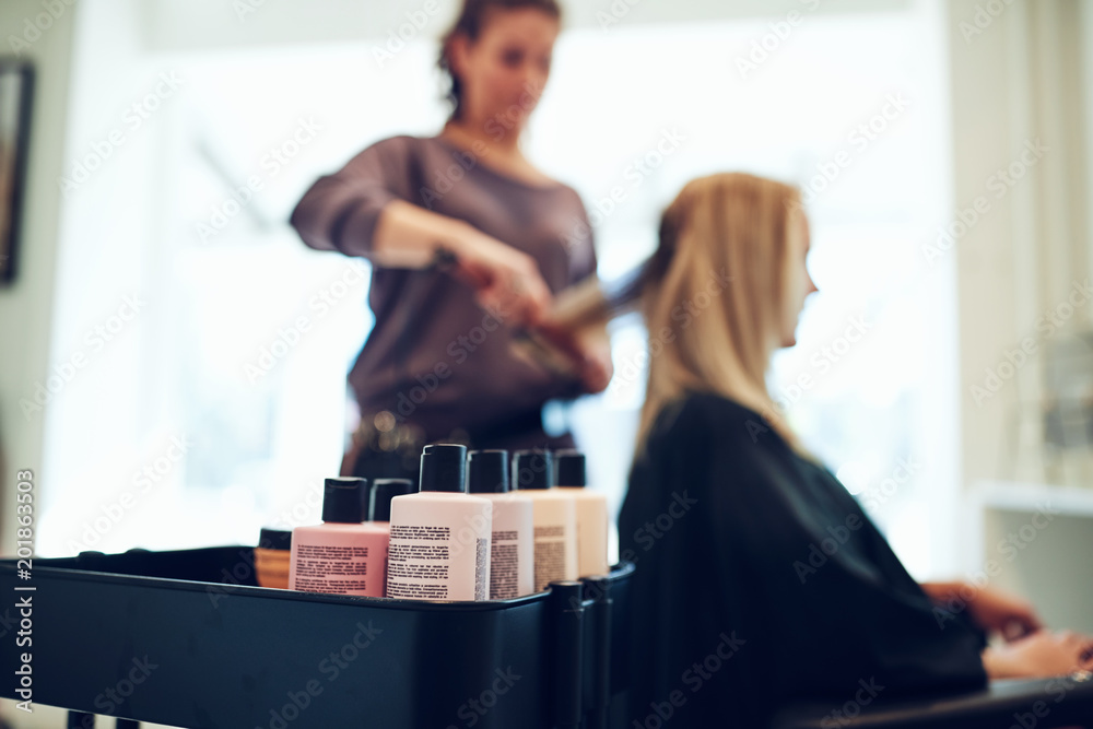 Bottles of styling products in a hair and beauty salon