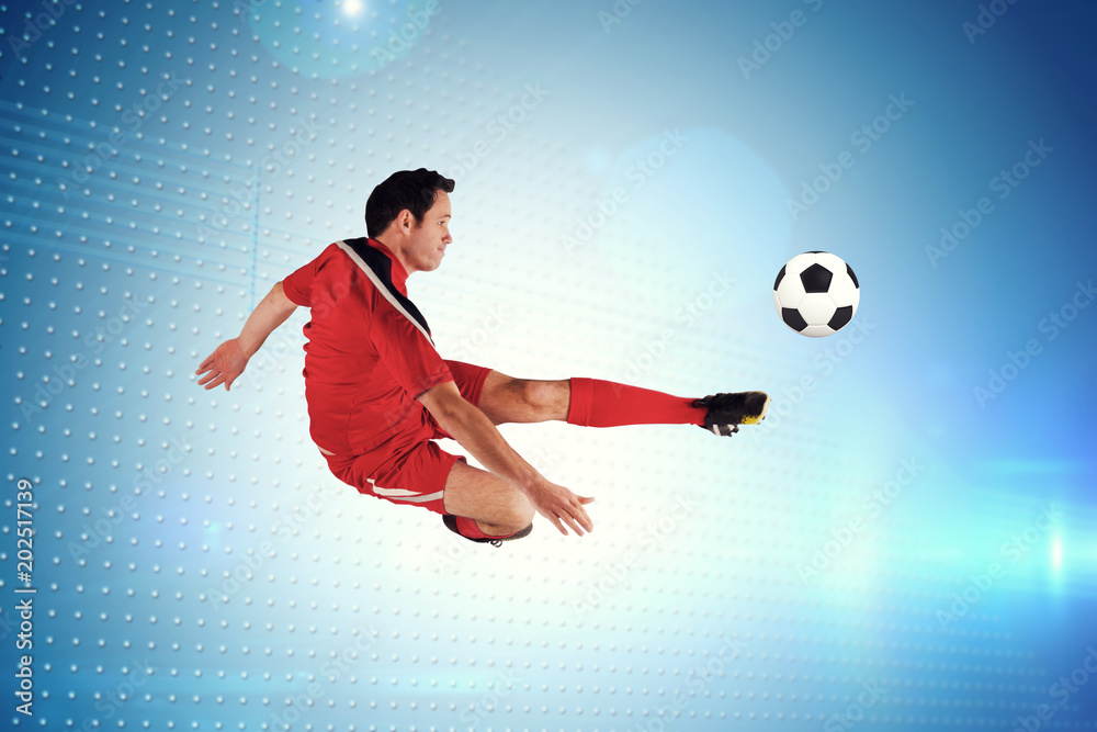 身穿红色衣服的足球运动员踢向像素技术屏幕