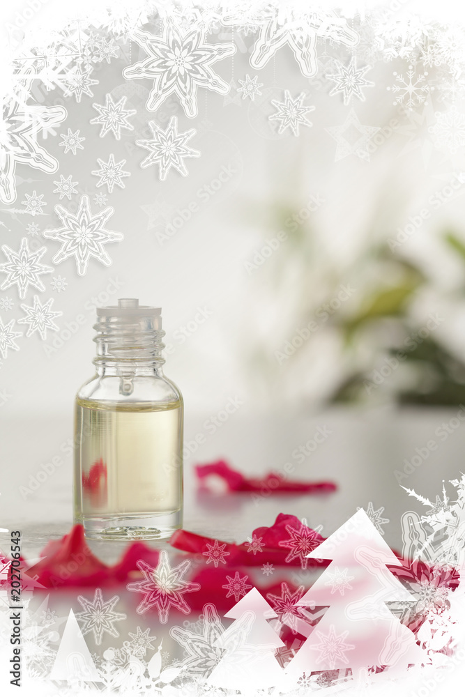 圣诞相框中的玻璃瓶和粉红色花瓣的合成图像