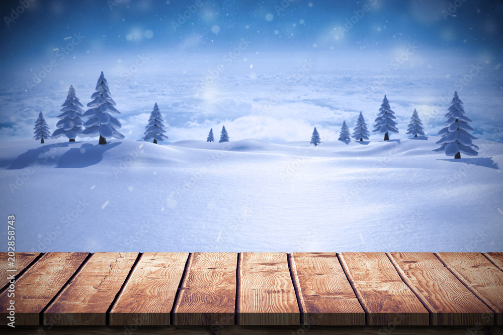 木制桌子与冷杉树映衬的雪景