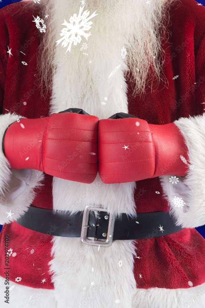 圣诞老人在蓝色雪花背景下戴着拳击手套
