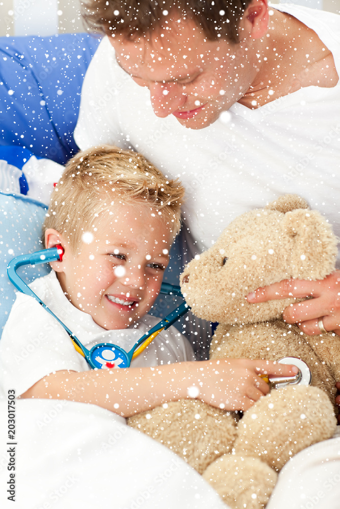 积极的父亲和生病的儿子在下雪时玩听诊器的合成图像