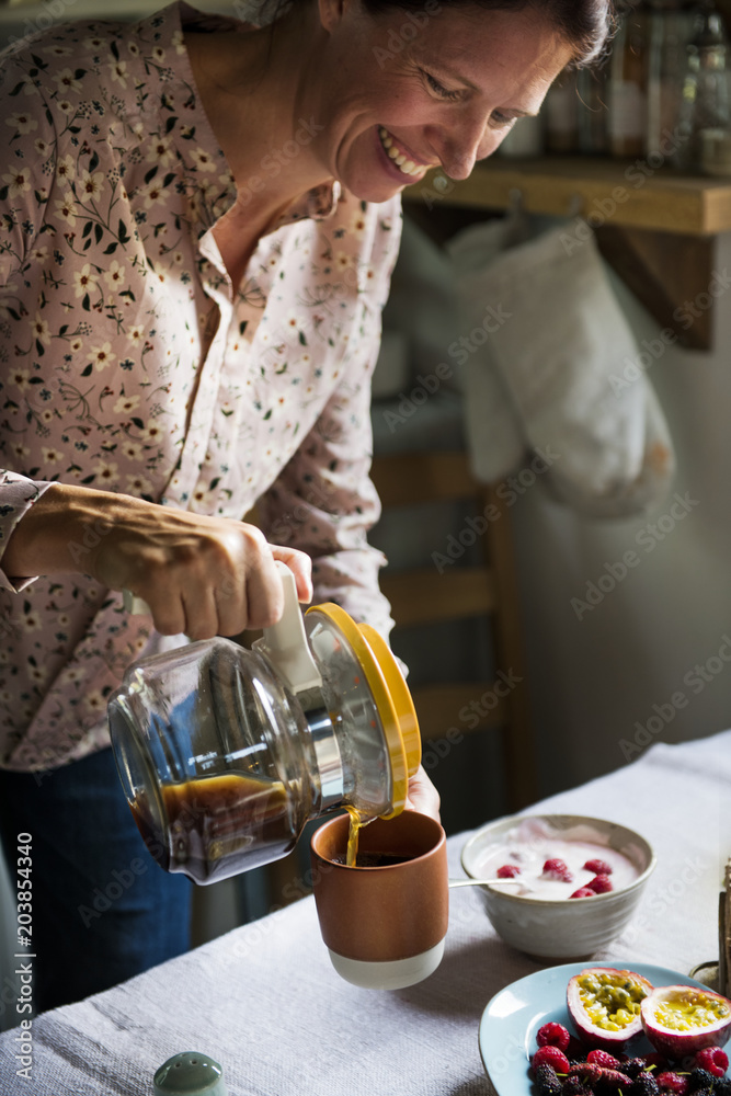 Woman serving hot coffee for breakfast