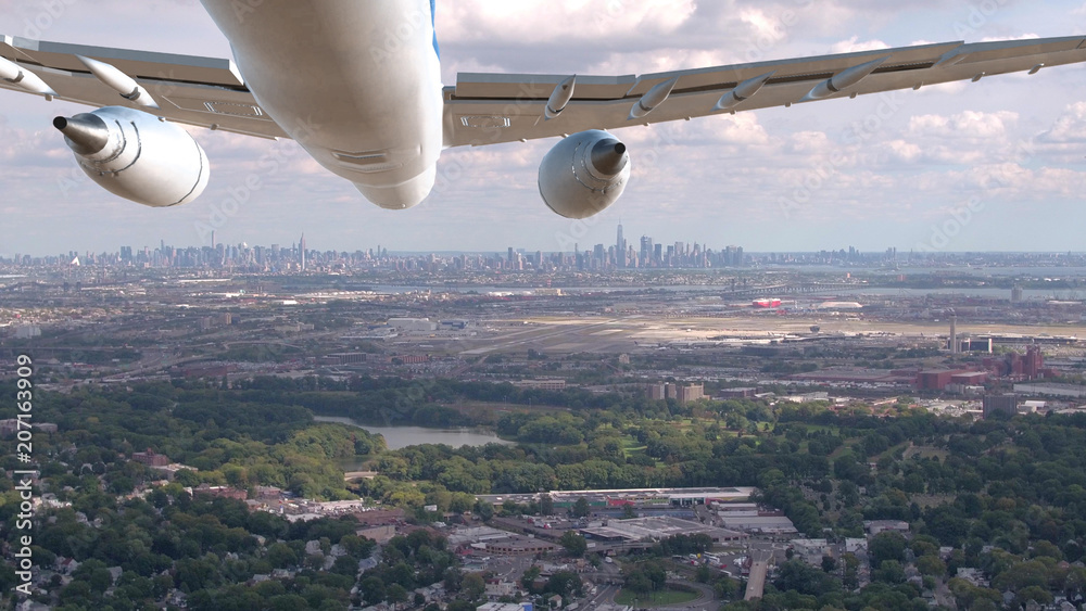 航空：飞机飞越工业区，飞向纽约。