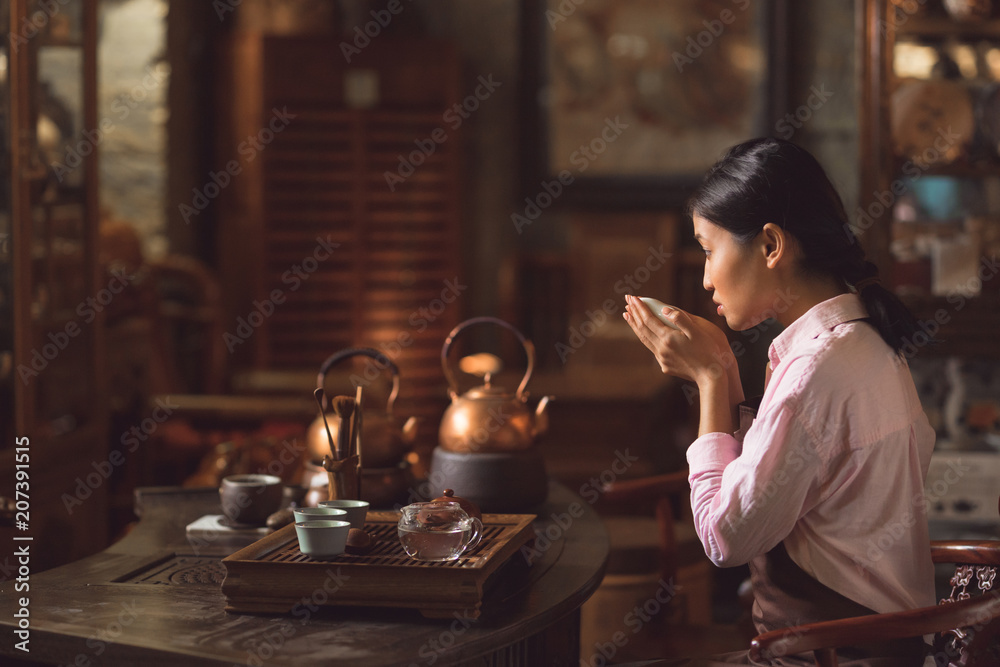 Young asian girl drinking tea