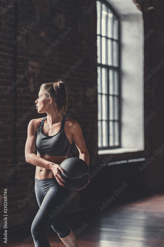 Sports woman with a ball indoors