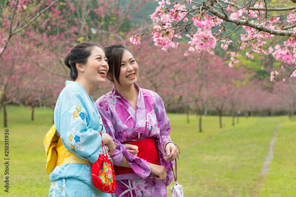 女士们站在樱花树旁开怀大笑