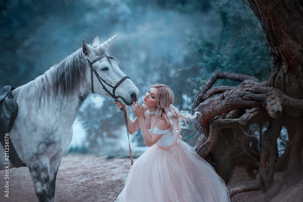 A fairy in a tender vintage dress hugs a unicorn. Fantastic magical, radiant horse. Background river