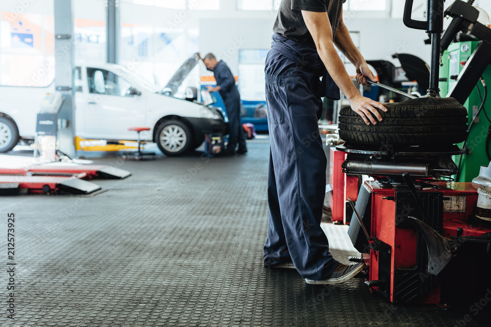 Car repair shop with mechanics working