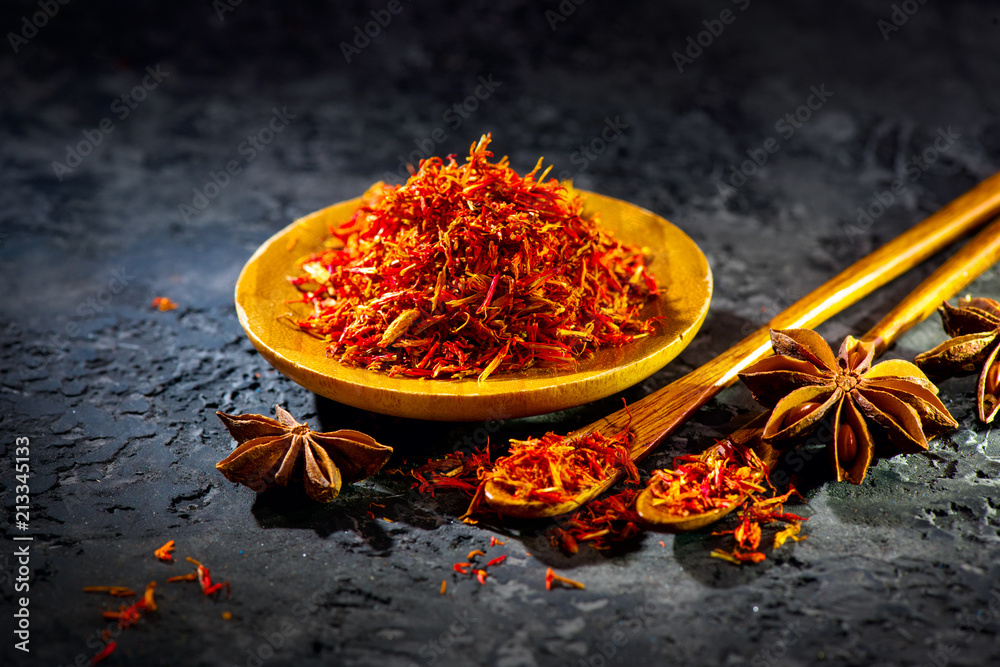 Saffron. Various Indian Spices on black stone table. Spice and herbs on slate background. Cooking in