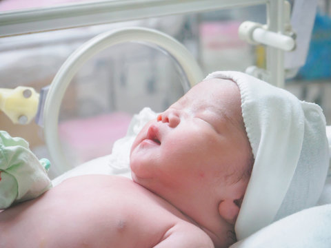 newborn baby infant sleep in the incubator at hospital