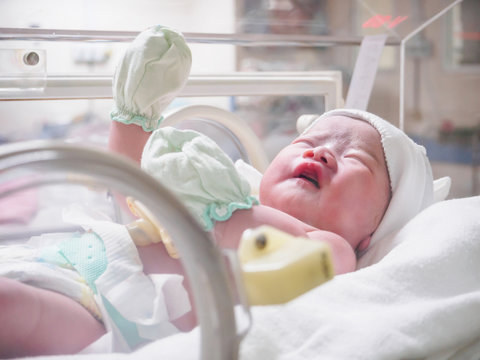 newborn baby infant sleep in the incubator at hospital
