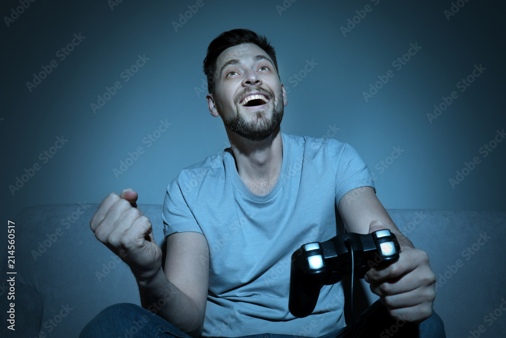 情绪激动的男人晚上玩电子游戏