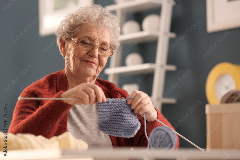 老年妇女在家编织保暖袜子