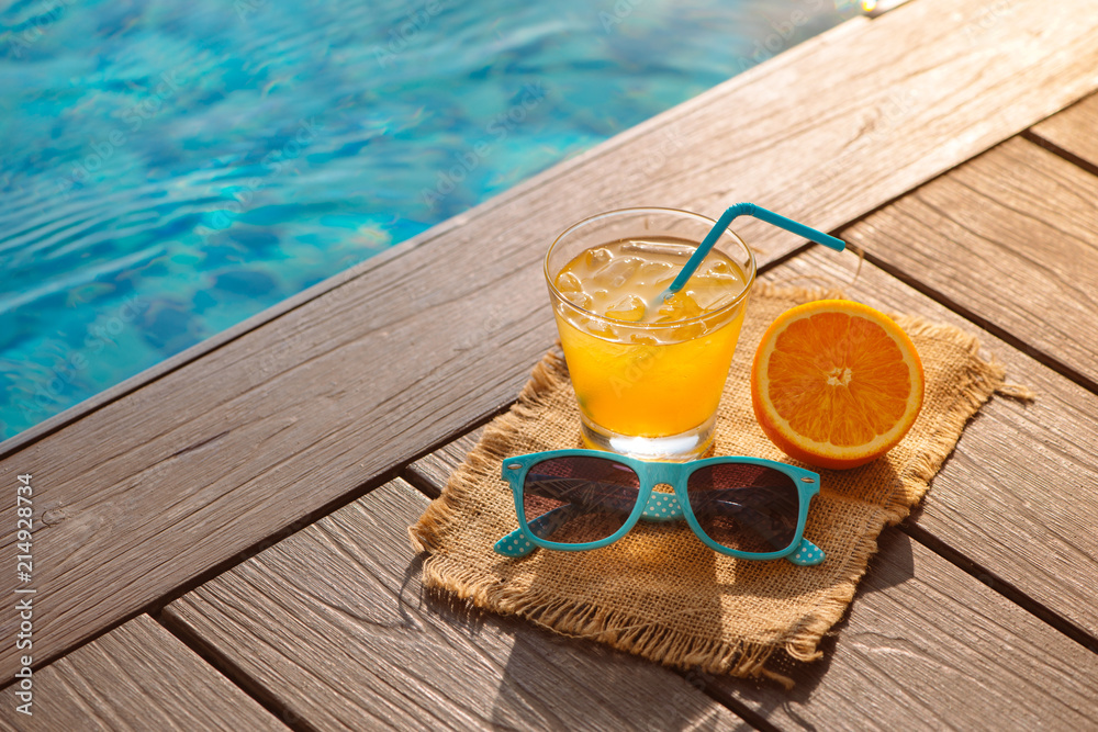 橙汁奶昔饮料，游泳池附近的太阳镜