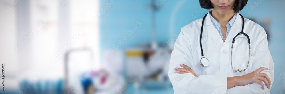 Composite image of doctor standing with arms crossed against