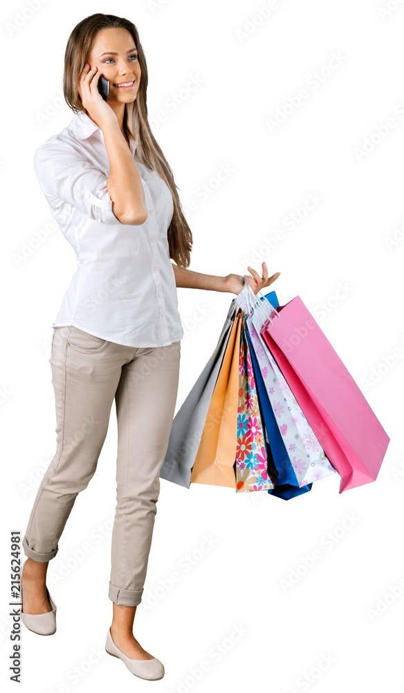 Portrait of a Woman Walking with Shopping Bags while Talking on