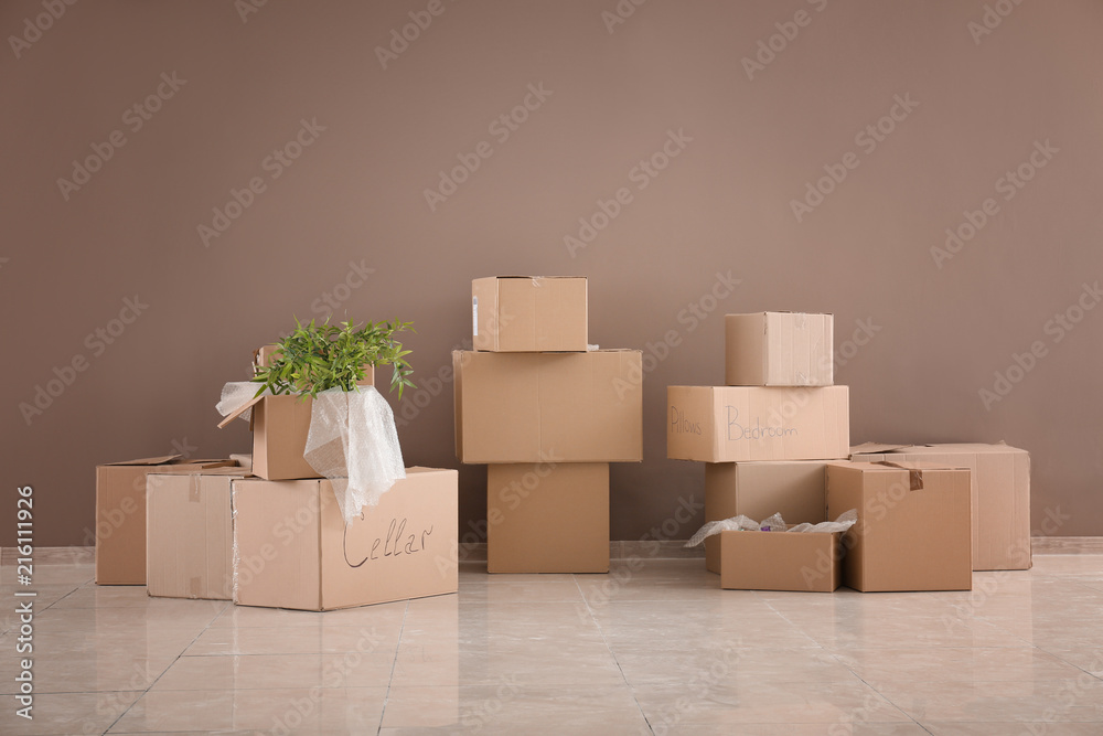 Packed carton boxes on floor near wall. Moving house concept