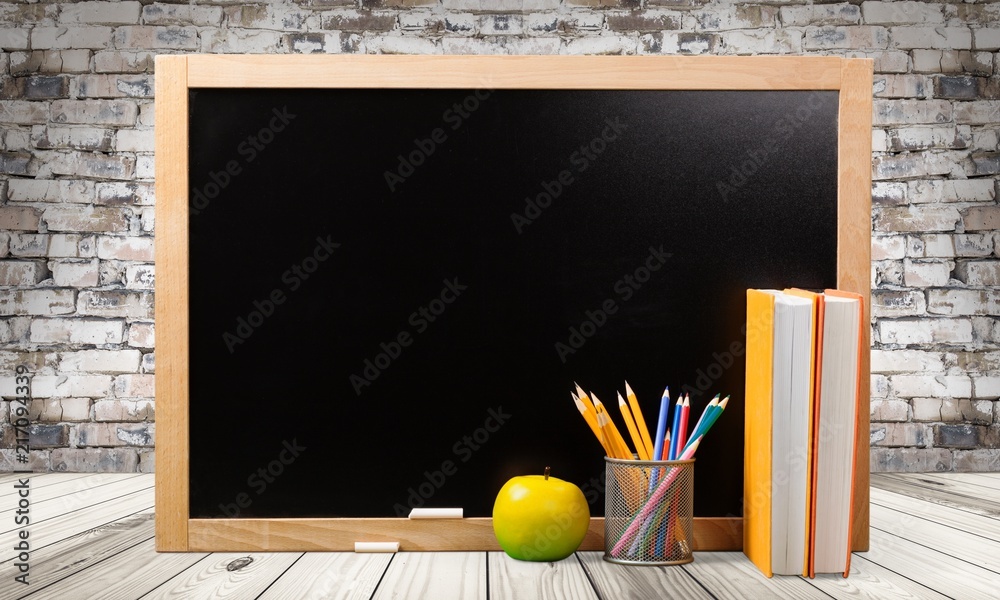 Stack of books and blackboard