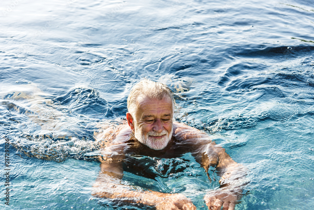 Senior man chilling in swimming pool