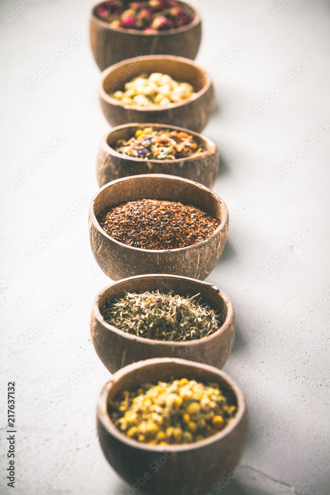 Assortment of dry tea in coconut bowls.