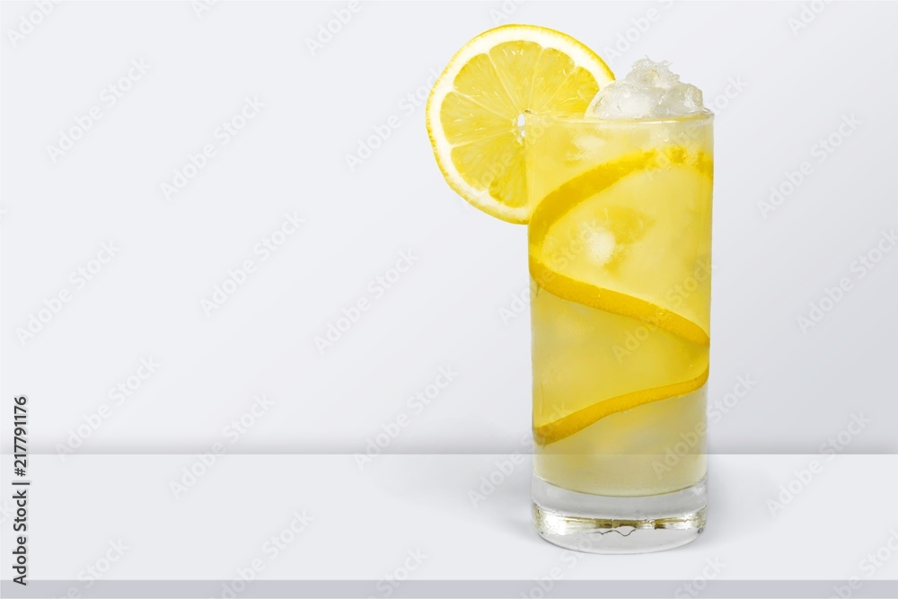 Lemonade with fresh lemon on desk