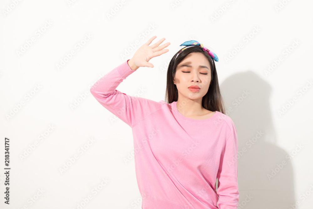 Portrait of a beautiful Asian girl covering face by hand of bright sun light. woman in a pink dress 