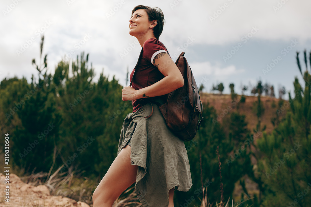 Female explorer walking through a forest
