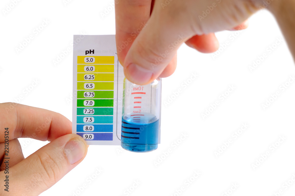 在家里测试水的pH值。男子通过比较测试小瓶中液体的颜色来确定水的pH