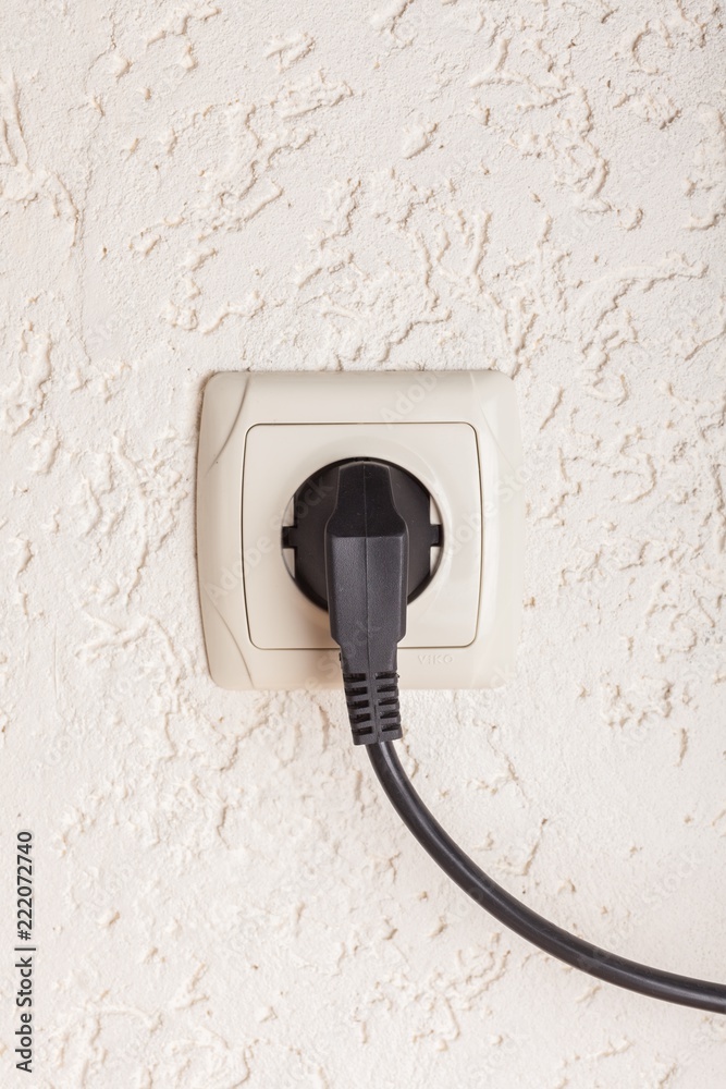Electric Plug and Socket on Wall