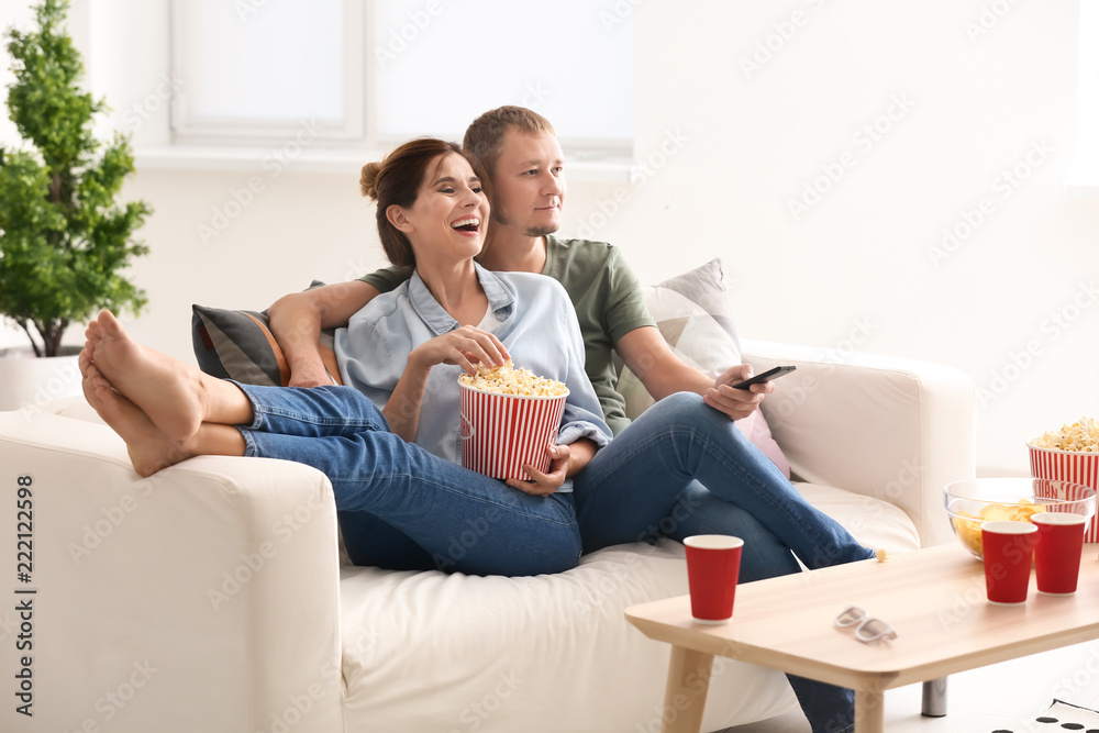 夫妇在家看电视时吃爆米花