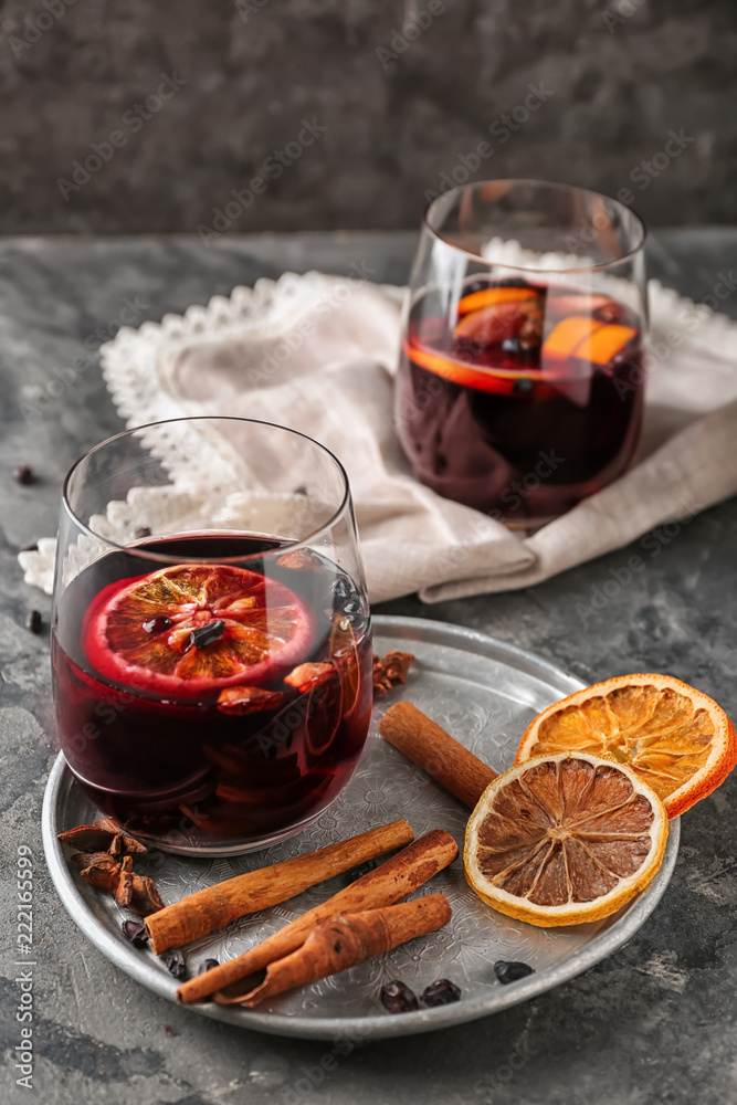 Glass of delicious mulled wine on metal tray
