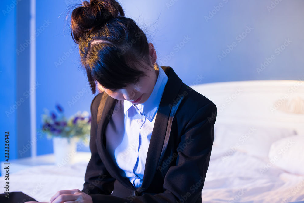 businesswoman feel tired on bed