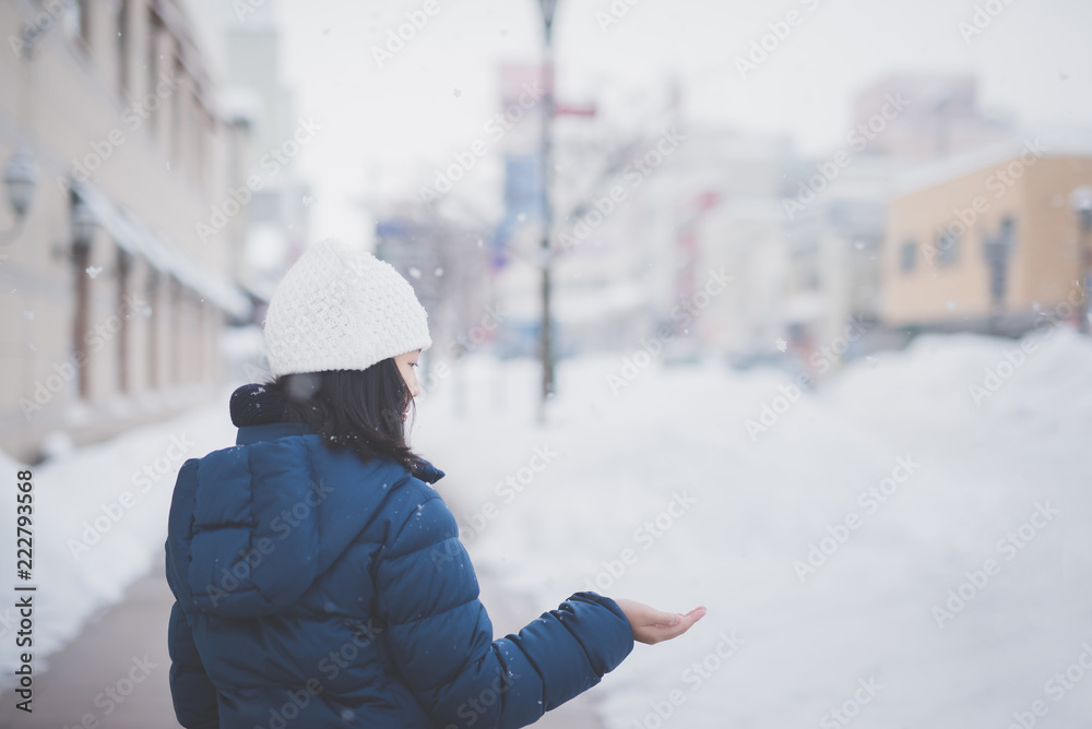  Asian girl enjoying snowfall