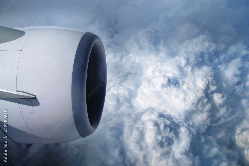 View of the sky and clouds from the airplane porthole. jet engine turbine look through aircraft wind