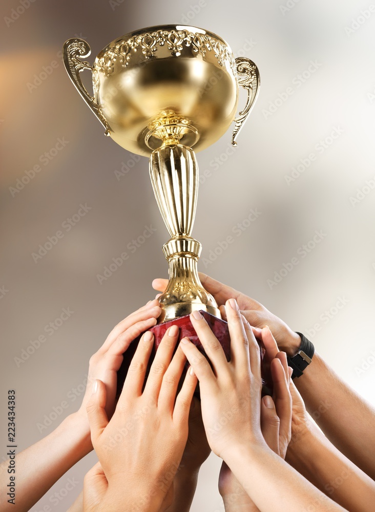Champion cup in hands on blur