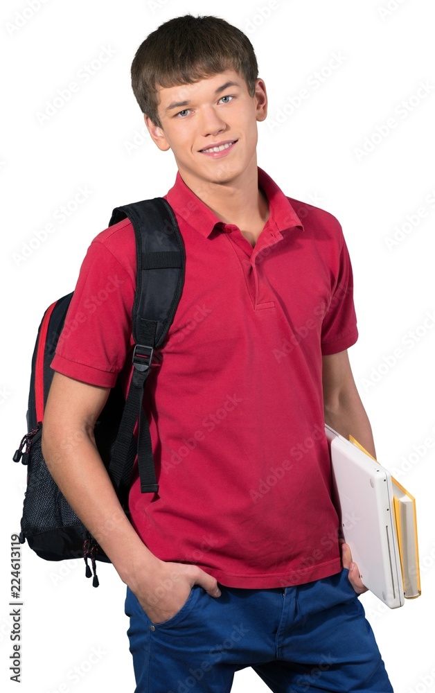 青少年男预科生拿着笔记本电脑和课本