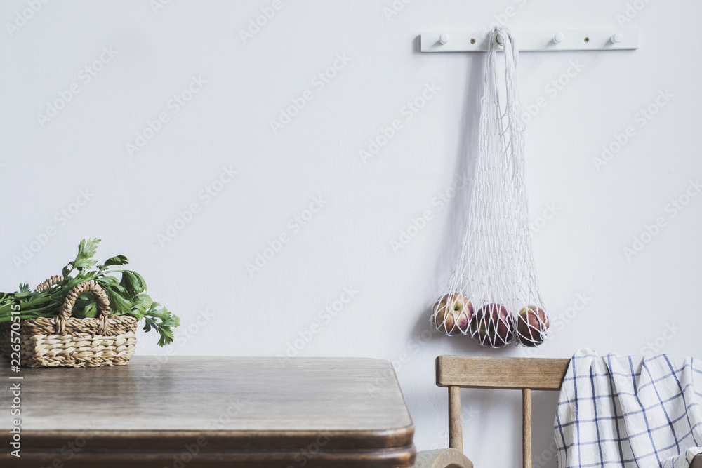 Vintage kitchen interior with copy space, straw basket, vegetables and bag with apples. Minimalist c