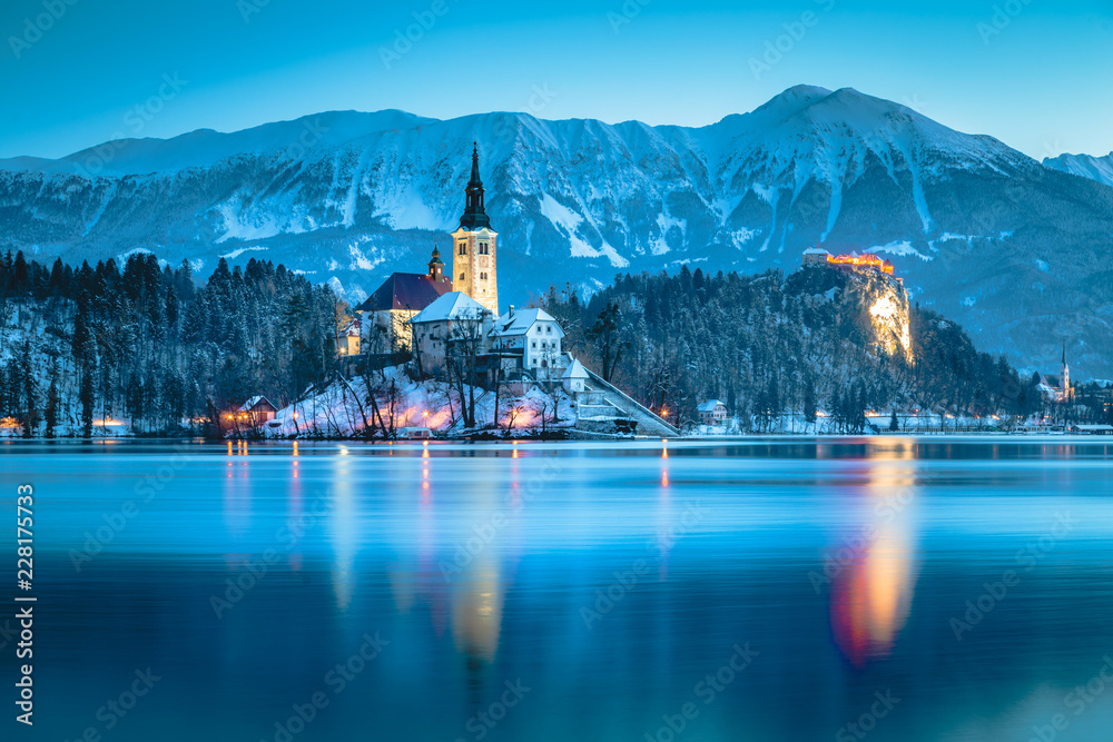 Twilight view of Lake Bled with Bled Island and Bled Castle in winter, Slovenia