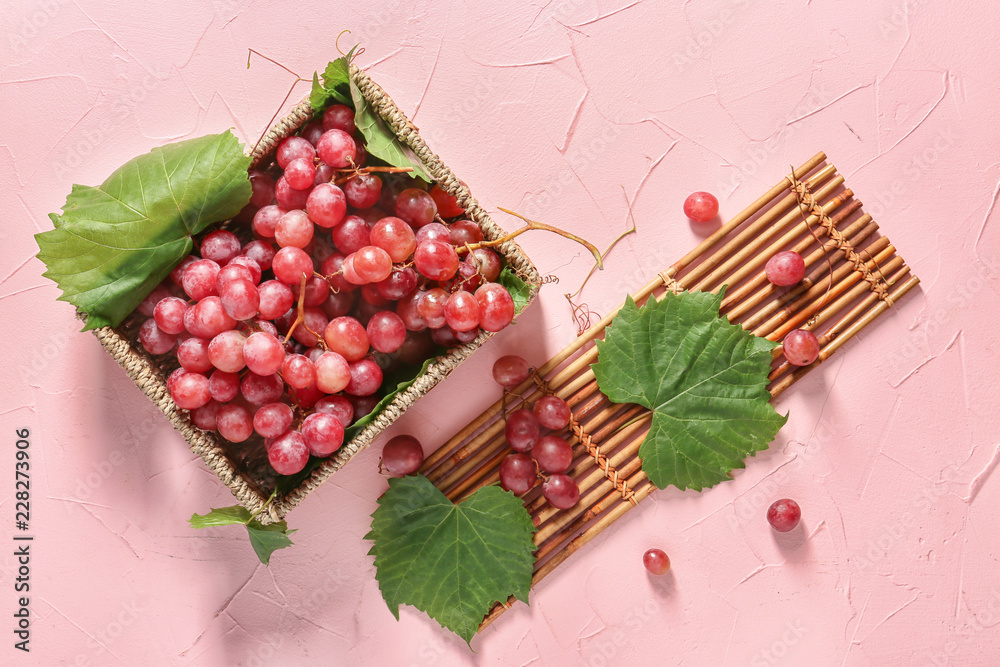 柳条盒子，背景是成熟的葡萄和竹垫