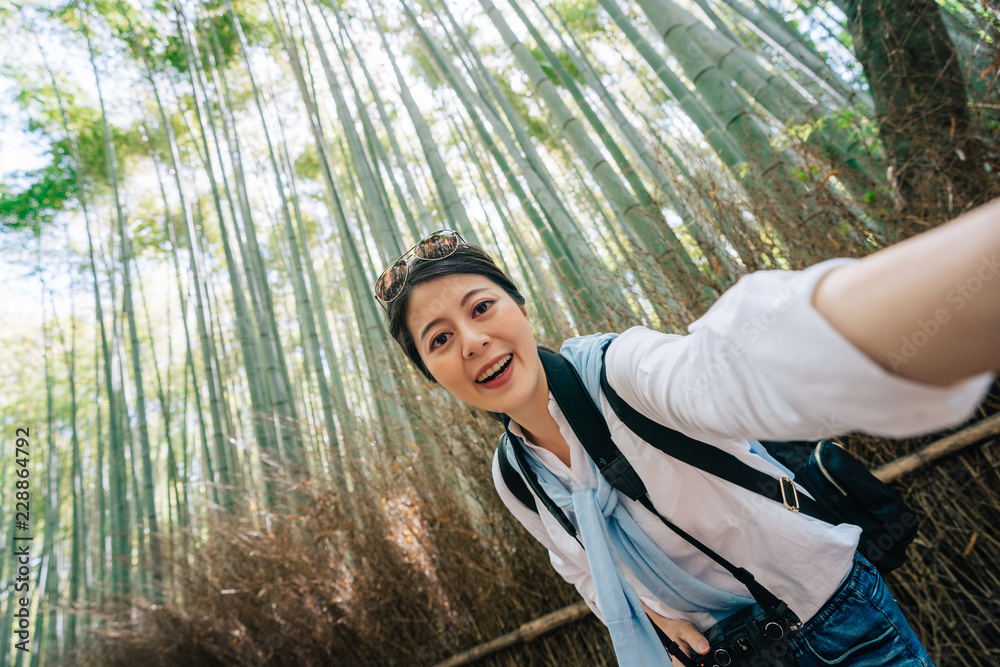tourist taking selfie in the bamboo grove