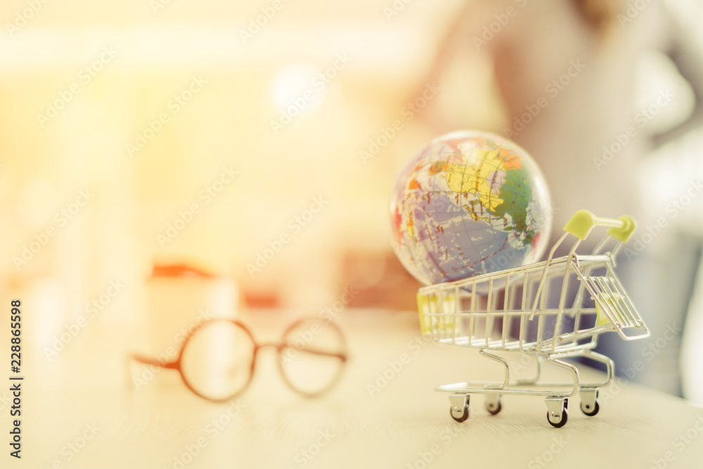 global business ideas concept with kart and world toy model blur background