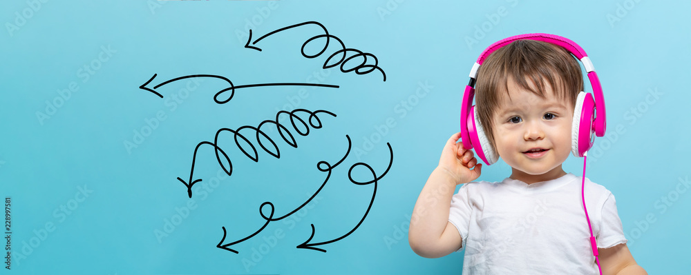 Curly arrows with toddler boy with headphones on a blue background