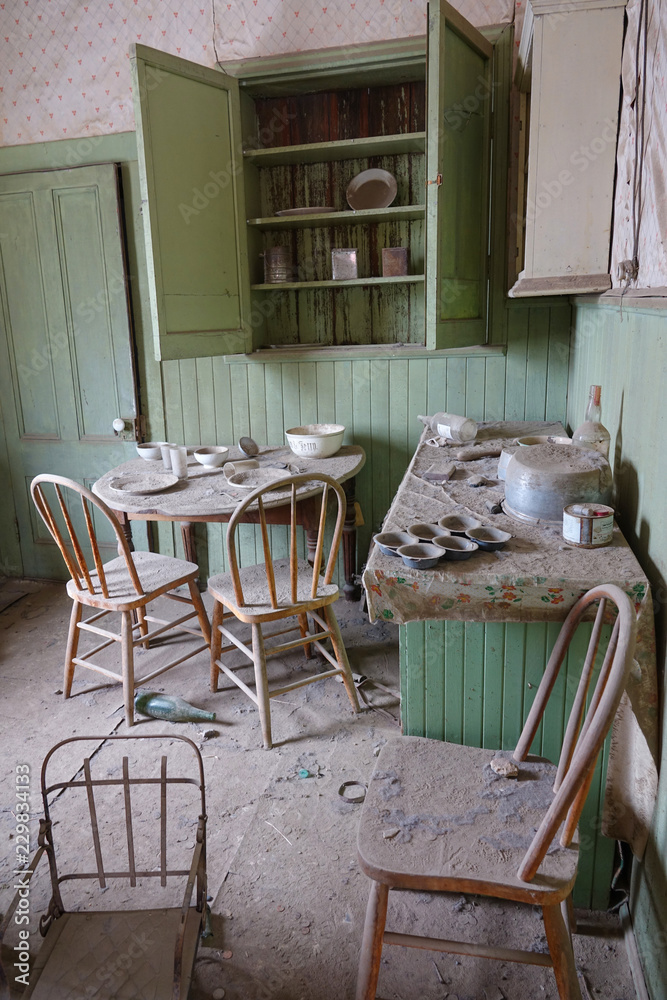 Dust gathering in the dining room in an abandoned house in a former mining town.