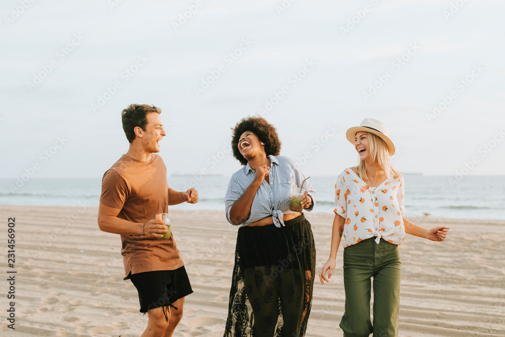 Friends dancing and having fun at the beach
