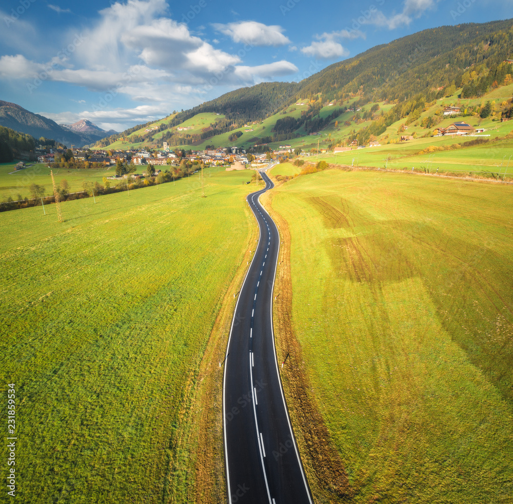 Aerial view of the road in mountain valley in Dolomites, Italy. Top view of perfect asphalt roadway,