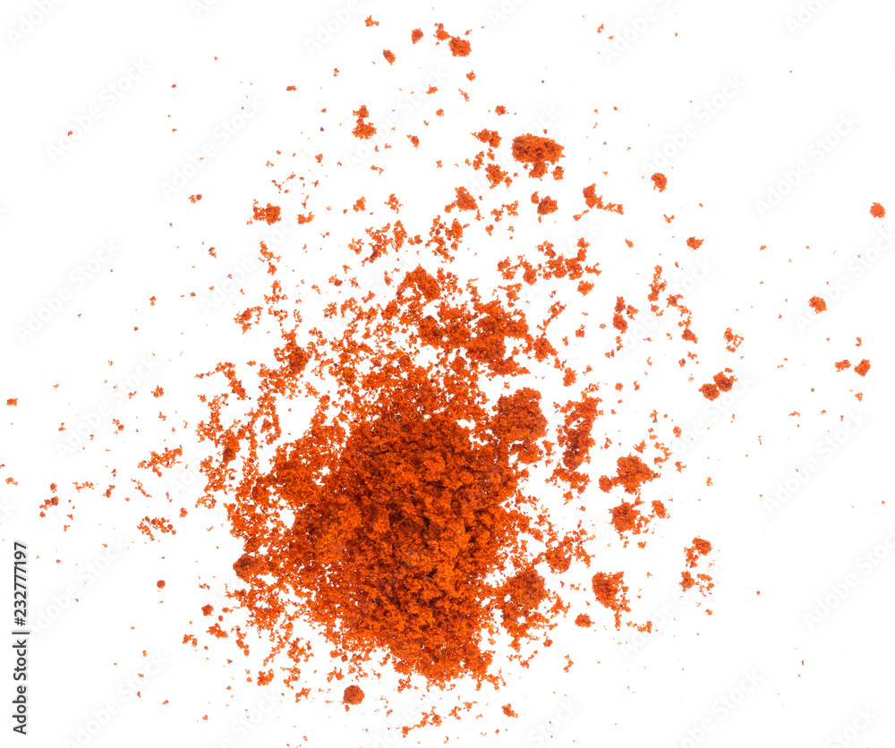 Scattered red paprika powder isolated on white background. Top view